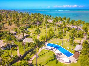 an aerial view of a resort with a swimming pool and the ocean at Pousada Reserva do Patacho in Pôrto de Pedras