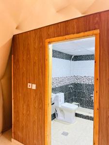 baño con aseo y puerta de cristal en Amir Rum luxury tents, en Wadi Rum