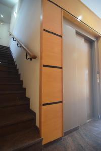 a door leading up to a staircase in a building at Hospedium GL Andújar Suites in Andújar +7 photos