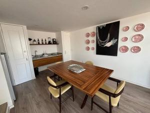 a dining room with a wooden table and chairs at Casa Alhaja - Amatista in Guadalajara