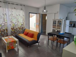 a living room with a couch and a table at La casita de Aitor; campo y playa en el Médano in El Médano