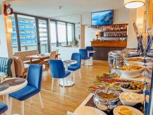 a restaurant with a buffet of food on a table at Seaside vip Hotel in Batumi