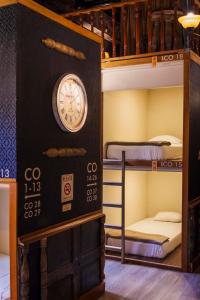 a room with bunk beds with a clock on the wall at The Clock Hostel & Suites in Cartagena de Indias