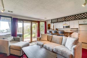 a living room with a couch and a table at Ski-InandSki-Out Wintergreen Resort Condo and Hot Tub! in Mount Torry Furnace