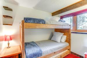 two bunk beds in a room with a window at Ski-InandSki-Out Wintergreen Resort Condo and Hot Tub! in Mount Torry Furnace +27 photos