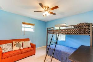 a bedroom with a bunk bed and a couch at Pet-Friendly Fort Pierce Home 1 Mi to Downtown! in Fort Pierce