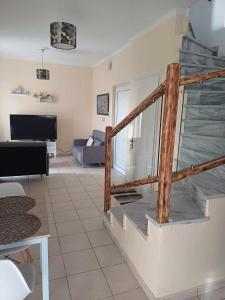 a living room with a staircase and a couch at IL TRAMONTO APARTMENTs 2 in Kanali