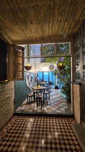 a patio with tables and chairs in a house at Casa Columpio in Mexico City +26 photos