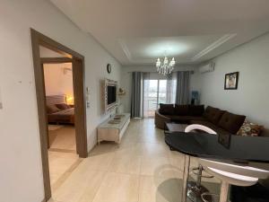 a living room with a couch and a table at PALM LAKE RESORT FOLLA in Monastir