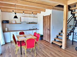 a kitchen and dining room with a table and chairs at Zefirowe Wzgórze in Polańczyk +22 photos