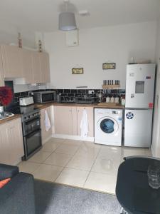 a kitchen with a stove and a washer and dryer at Hillside Residence in Carrick on Shannon