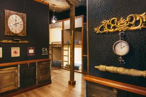 a room with a clock on the wall and a room with a bed at The Clock Hostel & Suites in Cartagena de Indias