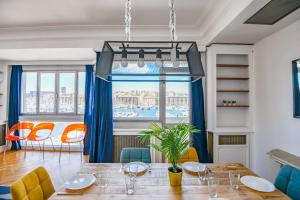 Un comedor con mesa y sillas y una ventana. en Vieux-Port - Vue exceptionnelle - 2 ch et clim, en Marsella