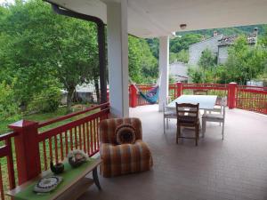 a porch with a table and a chair and a table and chairsktop at Casa BnB Pappappero Monti della Laga 