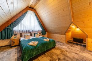 a bedroom with a bed in a attic at Willa Folk Prestige in Zakopane
