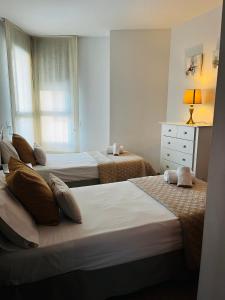 Un pat sau paturi într-o cameră la Travel Habitat - Ciudad de las Ciéncias