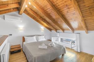 a bedroom with a bed with a wooden ceiling at Anastasia maisonette sea view in Kontokali
