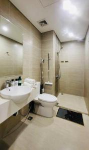y baño con aseo, lavabo y ducha. en Vivuhome 1BR Apartment Vinhomes Grand park en Gò Công
