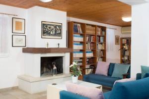 a living room with a couch and a fireplace at traditional village house in Ariokhórion