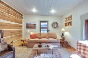 a living room with a couch and a table at Restored Buchanan Log Cabin on 9-Mile Creek! in Reba