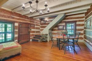 a dining room with a table and chairs at Restored Buchanan Log Cabin on 9-Mile Creek! in Reba