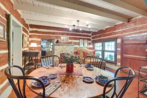 a dining room with a table and chairs at Restored Buchanan Log Cabin on 9-Mile Creek! in Reba