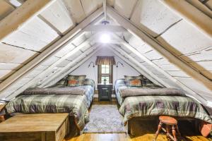 a room with two beds in a attic at Restored Buchanan Log Cabin on 9-Mile Creek! in Reba