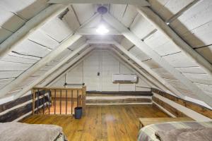 a room with two beds in a attic at Restored Buchanan Log Cabin on 9-Mile Creek! in Reba
