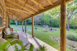 a wooden porch with a view of a park at Restored Buchanan Log Cabin on 9-Mile Creek! in Reba