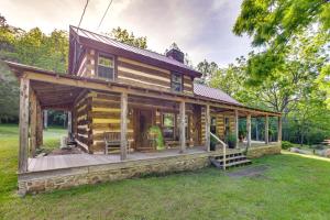 a log cabin with a porch and a deck at Restored Buchanan Log Cabin on 9-Mile Creek! in Reba