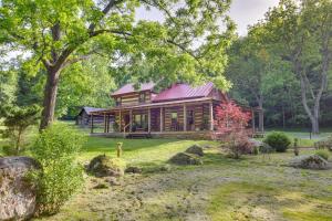 a log cabin in the woods with a yard at Restored Buchanan Log Cabin on 9-Mile Creek! in Reba