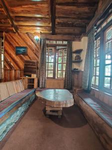 an empty room with a table in a cabin at Mt.Narsing Village Resort in Ravangla