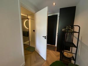 una habitación con una puerta blanca y una escalera en BnB Paradijs Oude Niedorp, en Oude-Niedorp