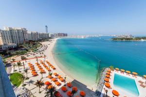 a view of a beach with umbrellas and the ocean at Sea View, Private Beach and Pool, Palm Jumeirah in Dubai