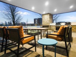 eine Terrasse mit Stühlen und einem Tisch auf dem Dach in der Unterkunft Home2 Suites By Hilton Bolingbrook Chicago in Bolingbrook