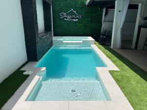 a swimming pool in the backyard of a house at Stacys Place #4 Studio Apartment in Port-of-Spain