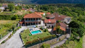 an aerial view of a house with a swimming pool at CASA DA ROSARINHO - Casa de Férias com Piscina - Arcos de Valdevez in Arcos de Valdevez