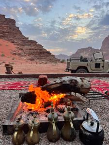 a camp fire in the middle of the desert at wadi rum traditional camp in Wadi Rum