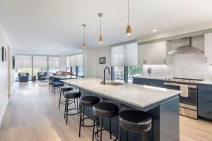 a kitchen with a large island with bar stools at Motif on Music Row in Nashville
