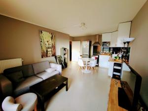 salon z kanapą i kuchnią w obiekcie Appartement confort Clichy JO 2024 w mieście Clichy