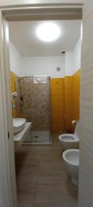 a bathroom with two toilets and two sinks and a shower at Maresol Residence in Bagnara Calabra