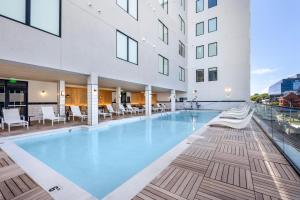 an indoor pool in a hotel with chairs and a building at Motif on Music Row in Nashville