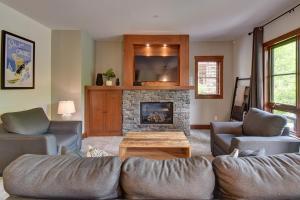 a living room with two couches and a fireplace at Tremblant Prestige - Étoile 1510-23 in Mont-Tremblant