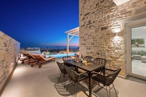 a dining room with a table and chairs at Elxis luxury villas Salty Pools! in Kalochorafitis