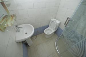 a bathroom with a sink and a toilet at OMX Hotel Remera in Kigali