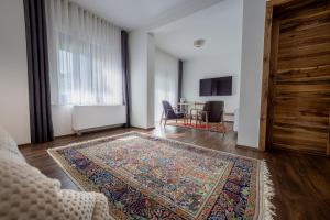 a living room with a rug on the floor at Doa Boutique Hotel in Peje +80 photos