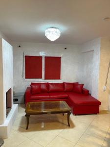een woonkamer met een rode bank en een salontafel bij Villa gioia- πρώην Chanel in Marathos