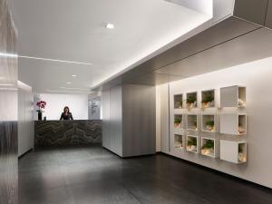 a woman standing at a counter in a lobby at AKA Rittenhouse Square in Philadelphia