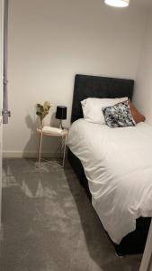 a bedroom with a bed and a side table at The Secret Stay In Walsall in Walsall