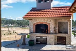 an outdoor pizza oven in a stone building at Holiday house OLIVE LAND in Gustirna +33 photos